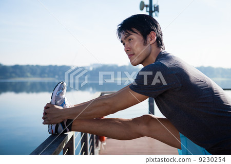 Young Asian Man Stretching Before Exercise 9230254