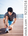 Young Asian Man Tying Running Shoelaces 9230258