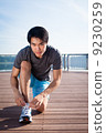 Young Asian Man Tying Running Shoelaces 9230259