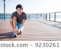 Young Asian Man Tying Running Shoelaces 9230261