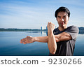 Young Asian Man Warming Up Before A Run 9230266