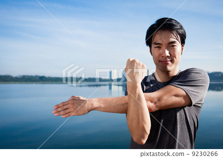 Young Asian Man Warming Up Before A Run 9230266