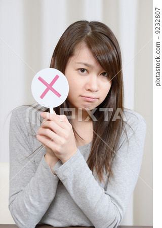 A young woman giving out x 9232807