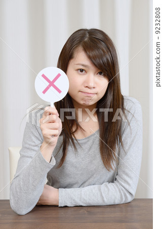 A young woman giving out x 9232808