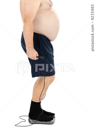 Fat man with skipping rope on scales Fat man with skipping rope on scales 9235983