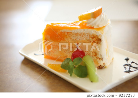 Orange cake on wood background Orange cake on wood background 9237253
