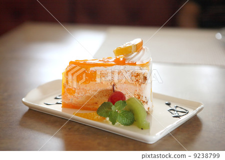 Orange cake on wood background Orange cake on wood background 9238799