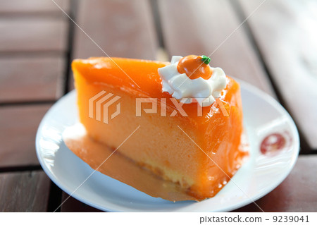 Orange cake on wood background Orange cake on wood background 9239041