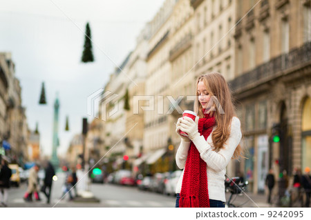Girl with take away coffee on a Parisian street Girl with take away coffee on a Parisian street 9242095