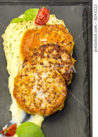cutlets fried in carrot sauce with mashed potatoes cutlets fried in carrot sauce with mashed potatoes 9243222
