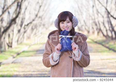 A woman giving a gift A woman giving a gift 9245044