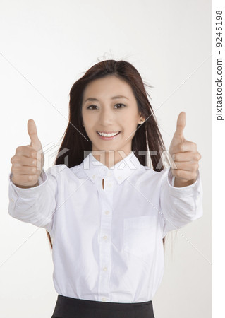 Business woman with two thumbs up, hair flying 9245198