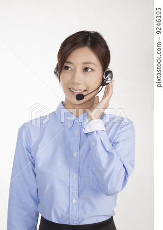 Office woman with headset with mic, holding onto headset 9246195
