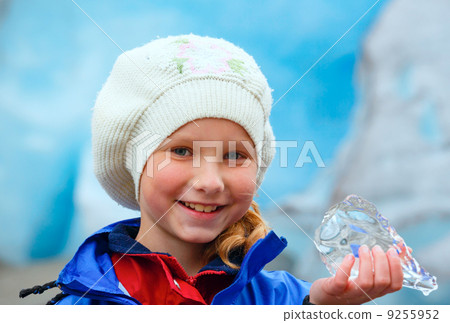 Girl with ice piece near Nigardsbreen glacier (Norway) Girl with ice piece near Nigardsbreen glacier (Norway) 9255952