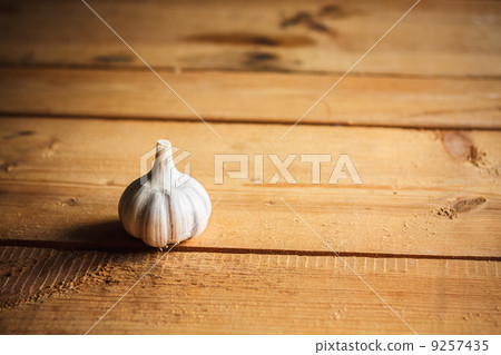 Raw garlic on wooden background Raw garlic on wooden background 9257435