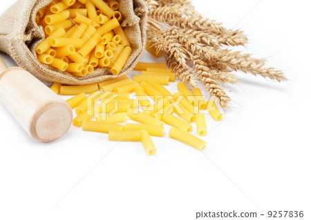Pasta in a canvas bag and ear on white background. Pasta in a canvas bag and ear on white background. 9257836