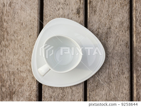 Empty coffee cup on wood floor 9258644