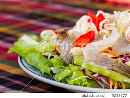 Spicy salad of fresh shrimp on plate 9258877