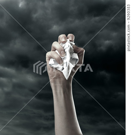 Sheet of paper pressed in fist 9260383