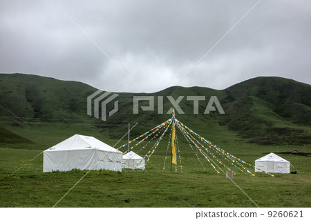 Colorful buddhist flags and tents in the mountains Colorful buddhist flags and tents in the mountains 9260621