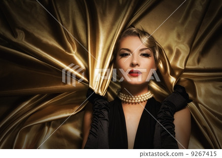 Lovely woman on golden fabric retro portrait 9267415