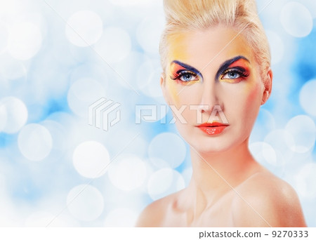 Beautiful woman in purple dress over abstact blurred background Beautiful woman in purple dress over abstact blurred background 9270333