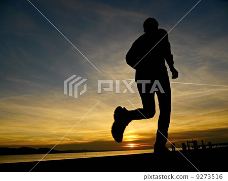silhouette of a jogger in sunrise 9273516