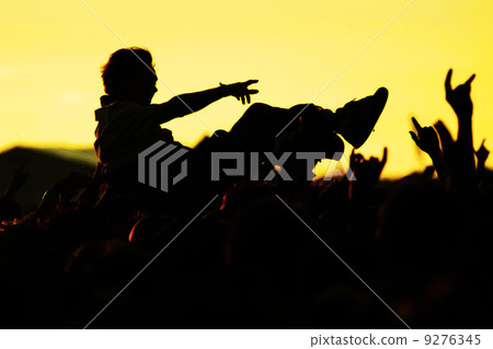 crowdsurfer open-air crowd cheering sunset crowdsurfer open-air crowd cheering sunset 9276345