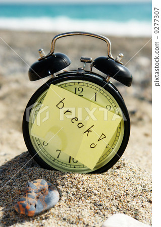 Time clock alarm clock at sunny beach 9277307