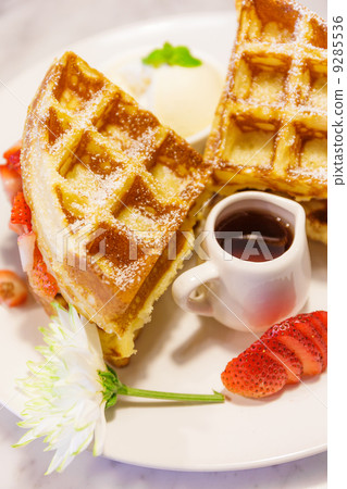 Baked waffles with syrup and strawberries Baked waffles with syrup and strawberries 9285536