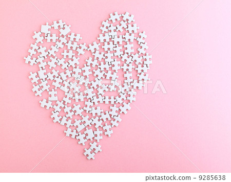 puzzle made heart sharp on pink background 9285638