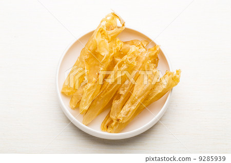 Dry fish gas bladder on white plate 9285939