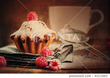 Fruitcake Decorated with Raspberry and icing sugar at the wooden Fruitcake Decorated with Raspberry and icing sugar at the wooden 9321883