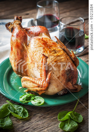 Whole Roasted Chicken with fresh green and wine, on wooden table Whole Roasted Chicken with fresh green and wine, on wooden table 9321884