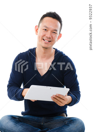 Asian man holding tablet computer isolated on white background. 9322937