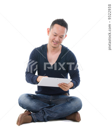 south east asian man.with a tablet in casual south east asian man.with a tablet in casual 9322938