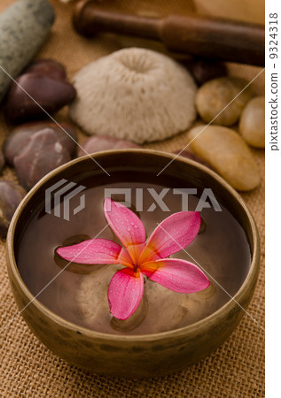 tropical spa setup with frangipani flower 9324318