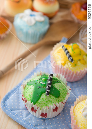 cupcakes muffins with cream fuits , breads, chocolate variety an 9324366