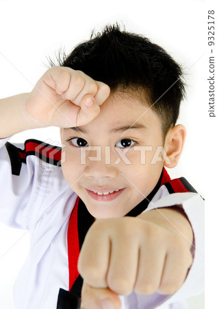 Taekwondo action by a asian cute boy Taekwondo action by a asian cute boy 9325178