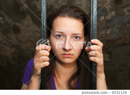 Young woman behind the bars Young woman behind the bars 9332126
