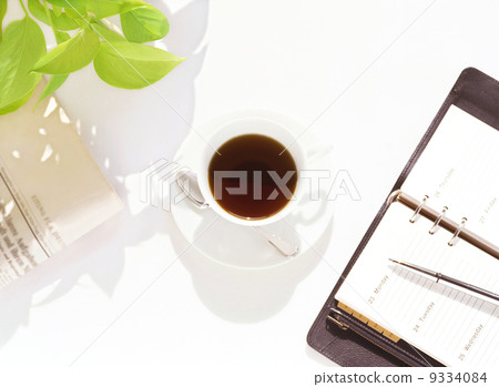 A notebook, newspaper and coffee 9334084