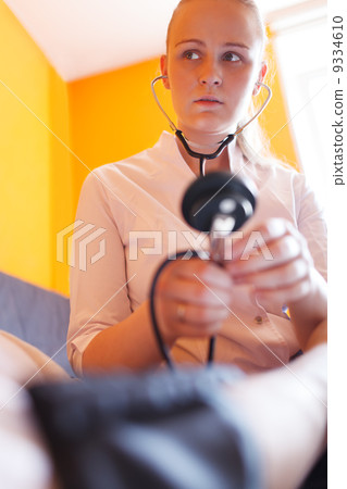 Nurse with stethoscope looks at the patient 9334610