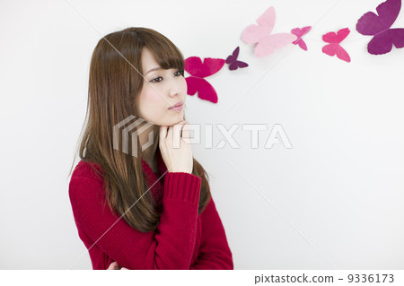 A young lady on the white wall 9336173