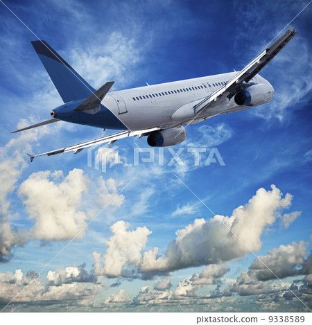 Jet cruising in a blue cloudy sky 9338589