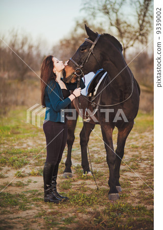 Young woman with a horse on nature 9339002