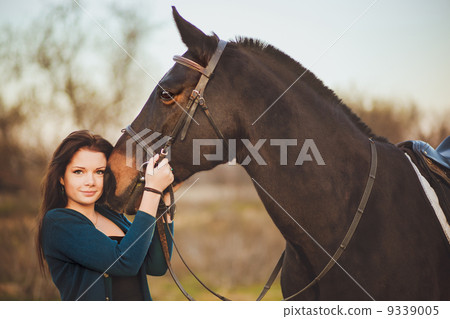 Young woman with a horse on nature Young woman with a horse on nature 9339005