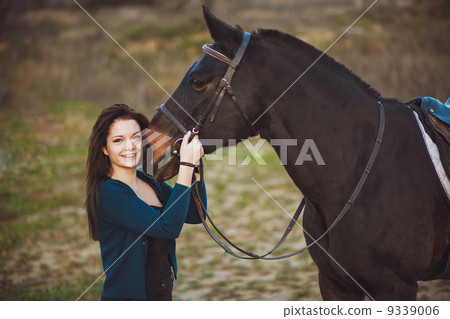 Young woman with a horse on nature 9339006