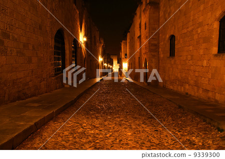 Medieval Avenue of the Knights at night, a cobblestone street in Rhodes Citadel , Greece 9339300