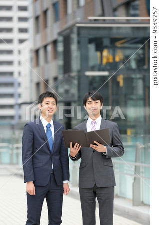 Two businessmen watching documents 9339757