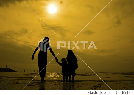 Silhouette group of kids playing at the beach 9346514